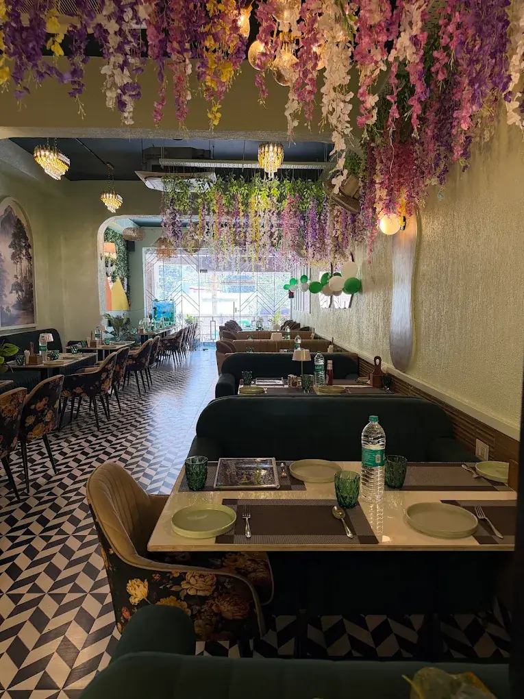 The Zaykara dining hall with hanging flowers and set tables